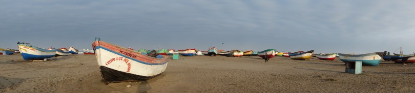 Brightly-colored "chalanas" bring fishers out to their bigger boats anchored offshore: one of many components of the fishing economy in San José. 